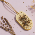 Lavender scented sachet  wax tablet styled in soft studio light with dried lavender sprigs, The House of Sneh