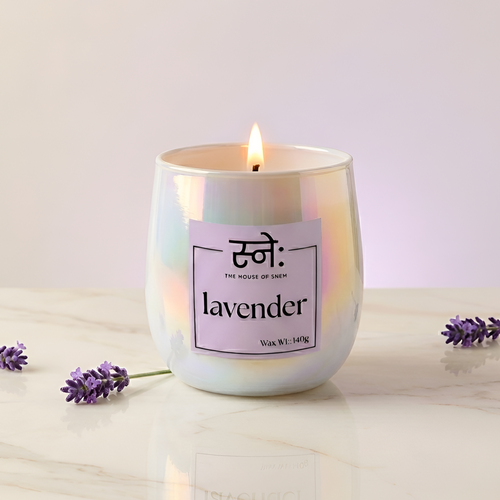 Lavender scented candle styled in warm studio light with botanical props, The House of Sneh